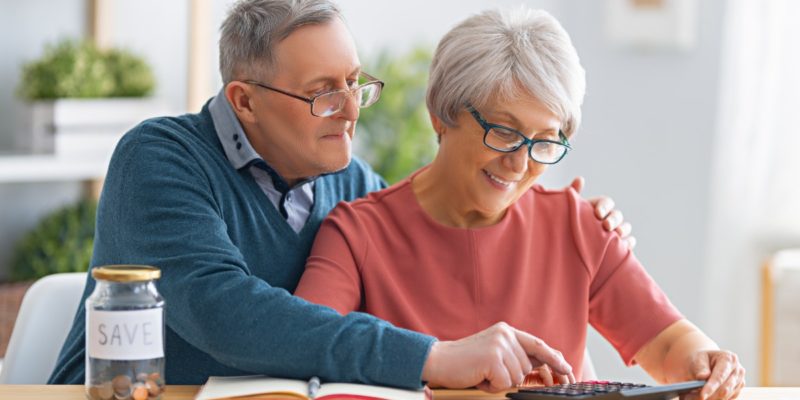 senior couple calculating how much senior living costs