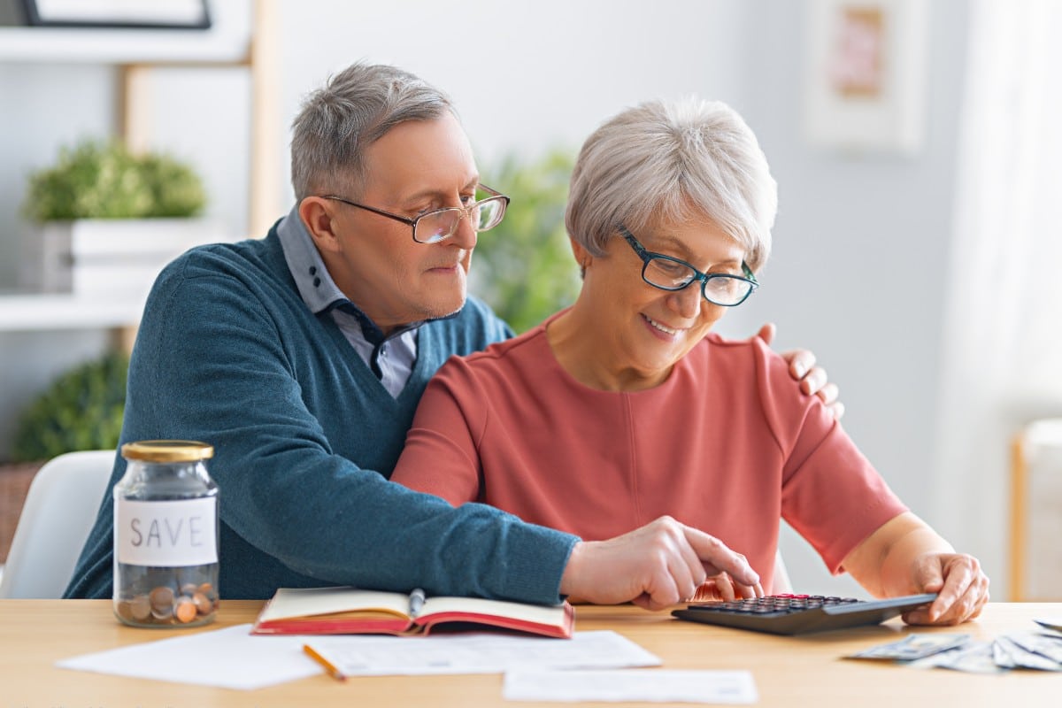 senior couple calculating how much senior living costs