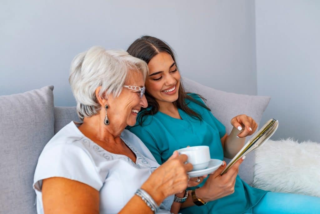 senior woman looking over schedule with health care assosicate