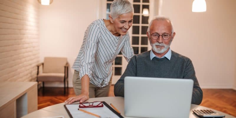 Senior couple looking at finances on computer