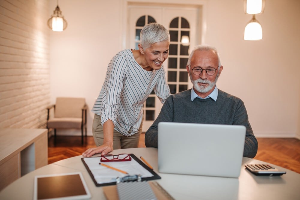 Senior couple looking at finances on computer