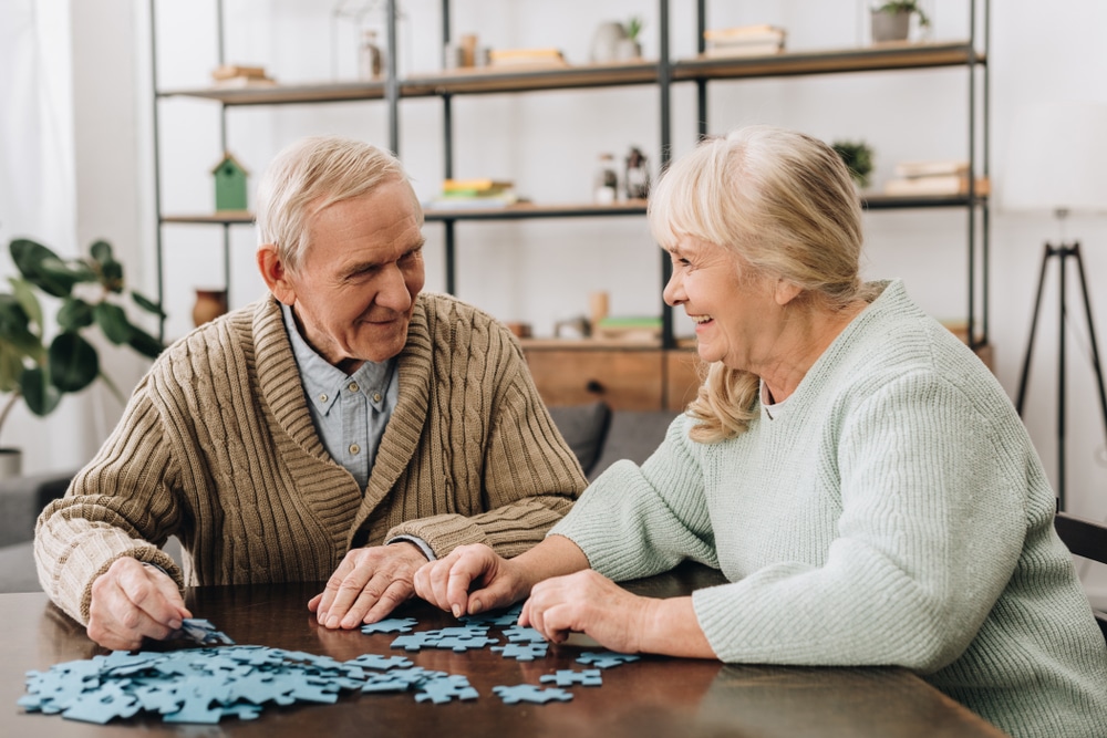 Senior couple putting a jigsaw puzzle together