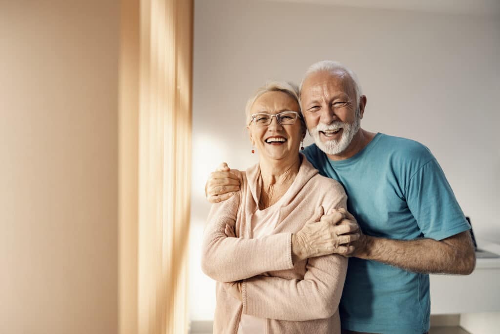 senior man and woman smiling at camera