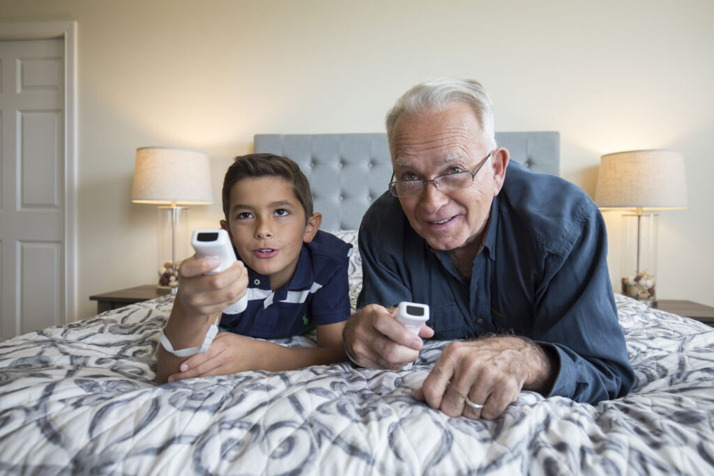 Senior watching TV with Grandson at Westminster Village