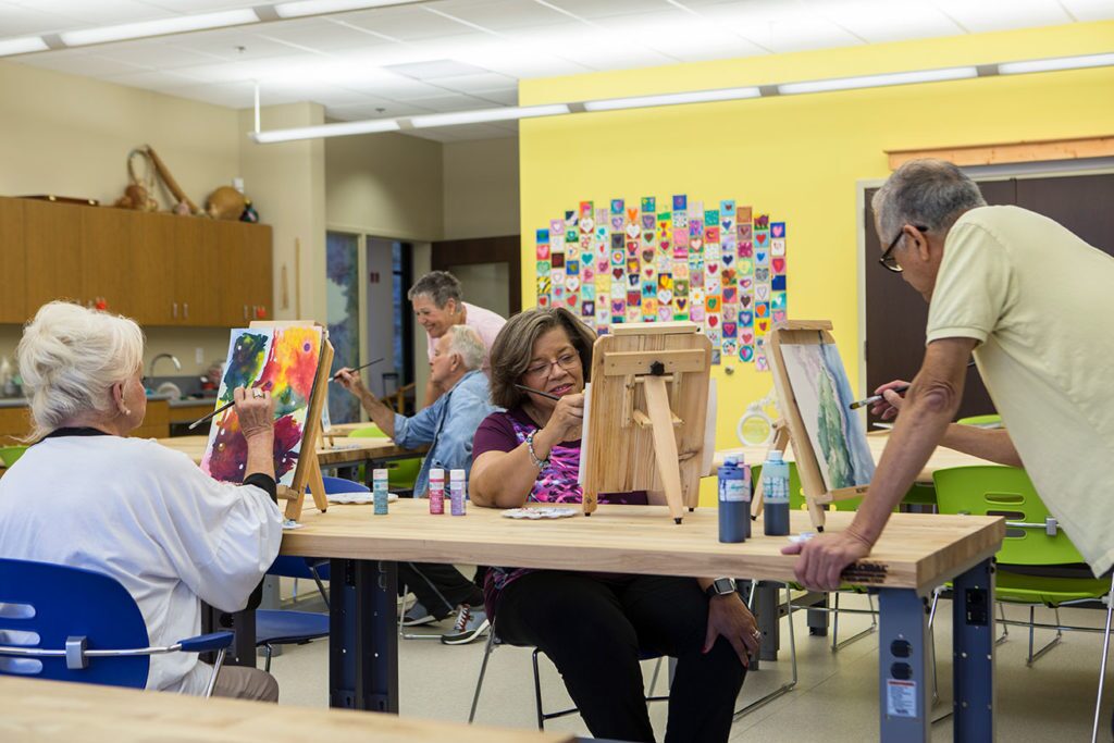 Seniors at Westminster Village by Lafayette, IN, in an art studio painting