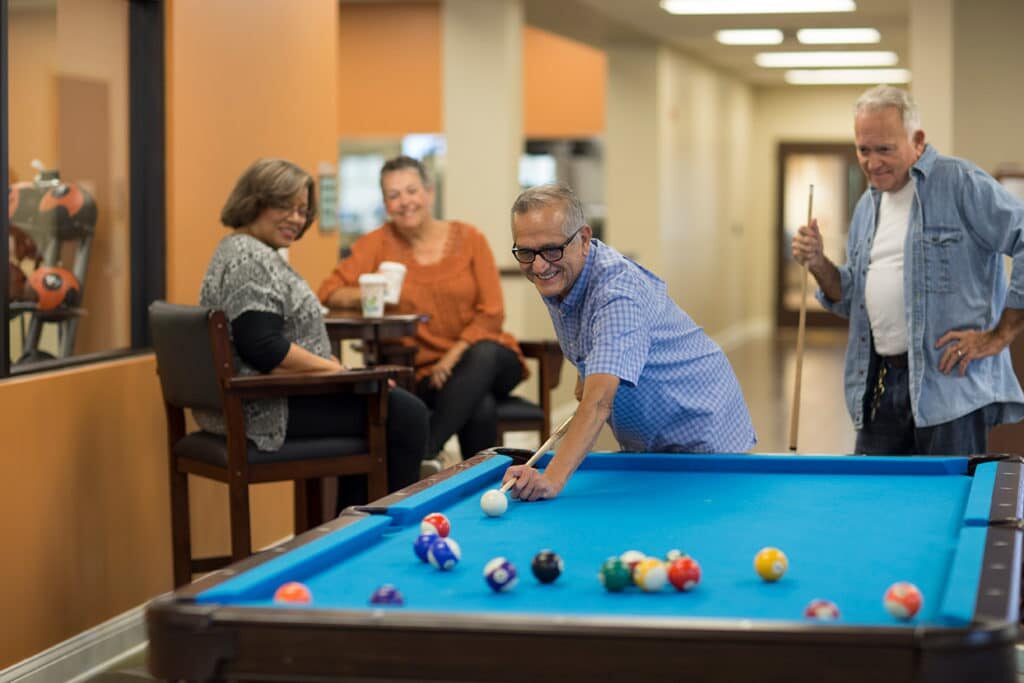 Seniors playing pool at Westminster Village, a senior living community in Tippecanoe County, IN.