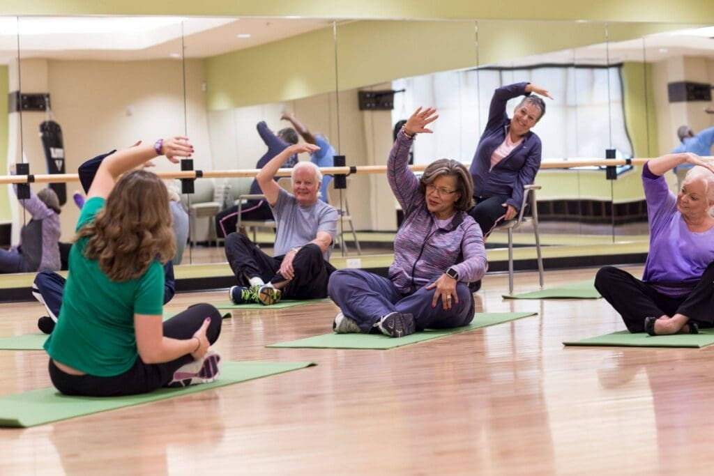 A class for seniors on balance exercises for elderly to improve stability and strength led by an instructor at Westminster Village at West Lafayette. 
